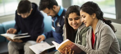 International students studying together indoors with books, supported by Starc Migration student visa services